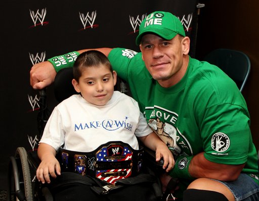 In this Monday, June 18, 2012 photo, seven-year old, Jonny Littman, poses with WWE superstar, John Cena, at the 300th Make-A-Wish for Cena in Uniondale, N.Y. It was the 300th wish granted by Cena, making him the most popular celebrity granter in Make-A-Wish history. (AP Photo/John Carucci)