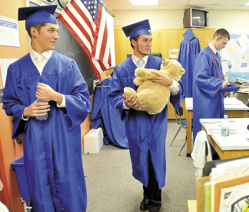 GRADUATES: Levi Tucker clutches the class mascot Mr. Bear before graduation ceremonies at Madison High School on Friday.