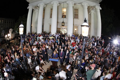 A crowd of people gathers in front of the Centre County Courthouse as Pennsylvania Attorney General Linda Kelly, center, following the conviction of former Penn State University assistant football coach Jerry Sandusky on multiple charges of child sexual abuse in Bellefonte, Pa., Friday.