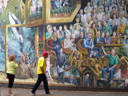 The "Inspiration State College" mural in State College, Pa., now has a blue ribbon – a symbol for awareness of child sexual abuse – on the portion that once included an image of Jerry Sandusky.