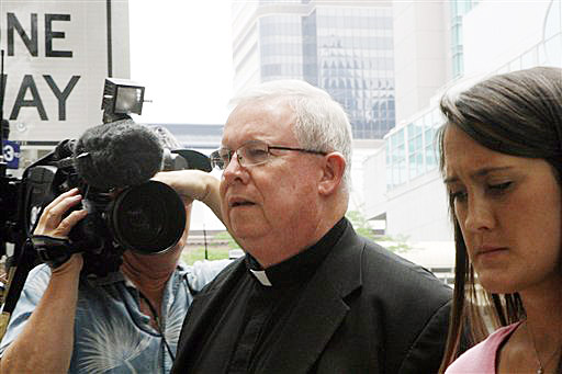 Monsignor William Lynn walks to the Criminal Justice Center before a scheduled verdict reading today in Philadelphia.