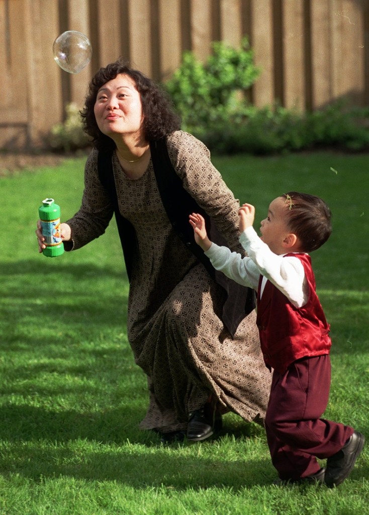 Phan Thi Kim Phuc plays with her son Thomas Huy Hoang in Toronto in 1997.