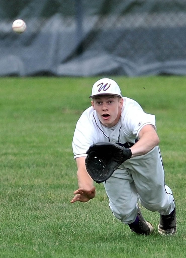 Staff Photo by Michael G. Seamans Waterville Senior High School center fielder Racean Wood, 21, dives and catches a fly ball in the first inning against Gardiner High School in the Eastern Class B Regional quarter finals game at Waterville High School Thursday. Waterville defeated Gardiner 11-1.