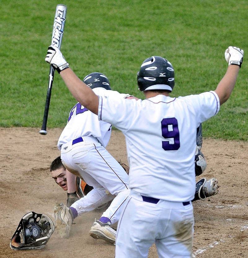 Staff Photo by Michael G. Seamans Gardiner High School catcher Jensen Orewiler, 30, bottom left, peers back after Waterville Senior High School's Kaleb Kane, 22, center crosses home plate to beat Gardiner High School 11-1 in the fifth inning of the Eastern Class B Regional quarter finals game at Waterville High School Thursday. Waterville's JT Whitten, 9, celebrates in the foreground. Waterville defeated Gardiner 11-1.