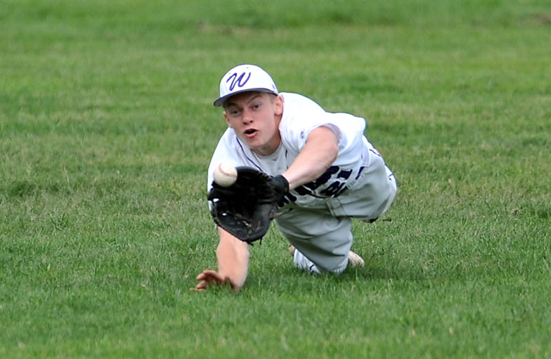 Staff Photo by Michael G. Seamans Waterville Senior High School center fielder Racean Wood, 21, dives and catches a fly ball in the first inning against Gardiner High School in the Eastern Class B Regional quarter finals game at Waterville High School Thursday. Waterville defeated Gardiner 11-1.