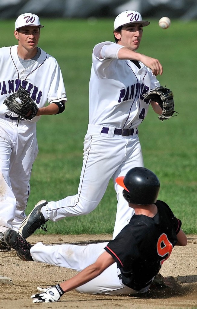 CLOSE PLAY: Waterville Senior High School shortstop Matt Lee (4) throws to first base as Winslow High School’s Mackenzie Michaud (9) tries to break up the double play earlier this season in Waterville. The Purple Panthers play in the quarterfinals Thursday against the winner of the Gardiner vs. Hermon preliminary-round game. Winslow hosts Oceanside at 4:15 p.m. today.