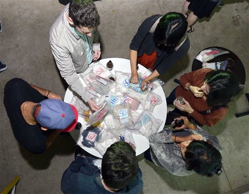 Partygoers reach for bagged shirts during a pheromone party in Los Angeles.