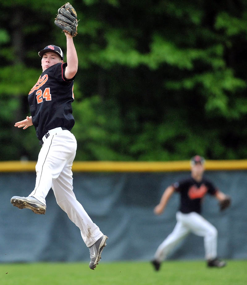 Staff Photo by Michael G. Seamans Winslow High School shortstop Dylan Hepworth, 24, makes a jumping catch to rob Oceanside High School of a hit in the third inning in the Eastern Class B preliminary game in Winslow.
