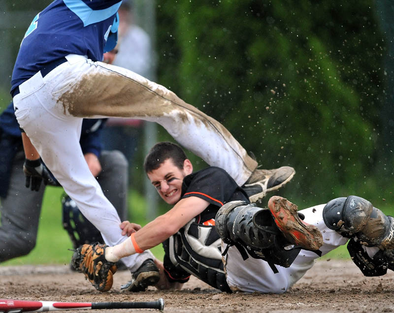 Staff Photo by Michael G. Seamans Winslow High School catcher Mike McLaughlin, 14, bottom collides with Oceanside High School's Billy Joyce, 11, at home plate in the 4th inning in Eastern Class B preliminary game in Winslow. Joyce was safe at home.
