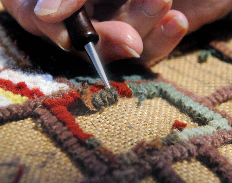 Julie Stewart, of Litchfield, hooks a rug during the Fiber Frolic Fair on Saturday at the Windsor Fairgrounds. The fair continues through Sunday and the fairgrounds are located on Route 32 between Routes 17 and 105.