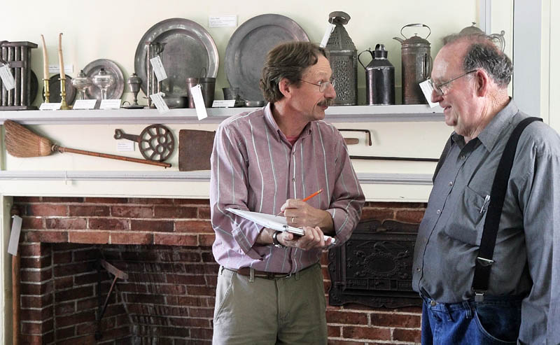 ASSESSING HISTORY:Conservator Ronald Harvey, left, of Lincolnville takes notes while chatting Lee Granville, curator of the Skowhegan History House Museum & Research Center, on Wednesday. Historical assessors have chosen the Skowhegan History House as one of only a handful in the nation for national historic designation.