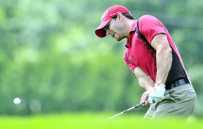 Staff photo by Joe Phelan Jeremiah Shields chips onto 12th green on the first day of the Charlie's Maine Open Championship on Tuesday at the Augusta Country Club in Augusta. Shields finished with a two under par score of 68 and was early leader after the morning session.