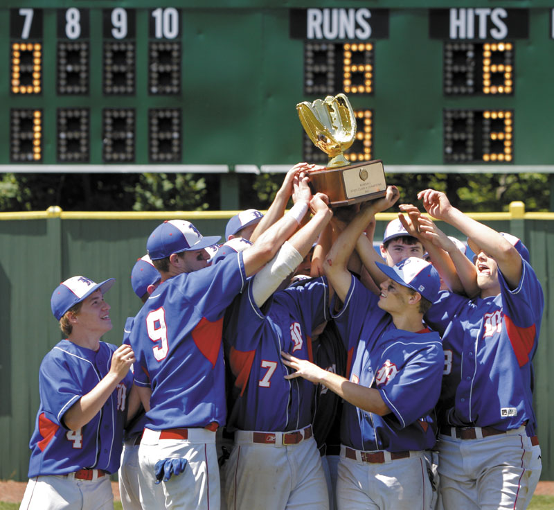 Messalonskee baseball players lift the state championship trophy after beating Scarborough 6-3 in the Class A title game Saturday at St. Joseph’s College in Standish.