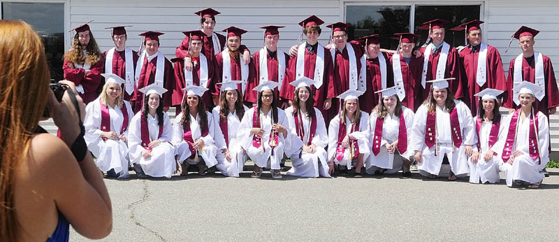 The Class of 2012 lines up as Noell Acord takes a group shot before graduation on Saturday afternoon at Richmond High School.