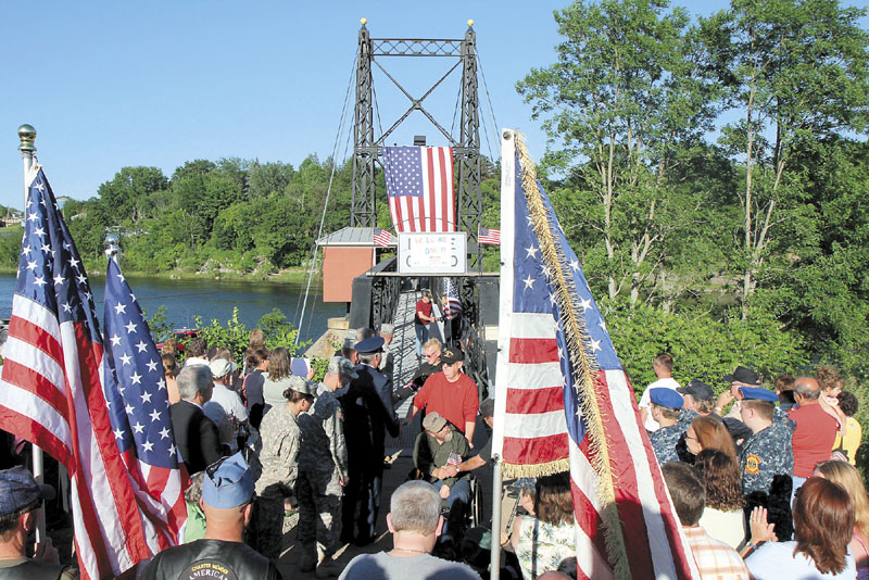 Vietnam veterans are greeted as they cross the Two-Cent Bridge from Winslow into Waterville during a Vietnam Veteran Homecoming ceremony on Thursday.