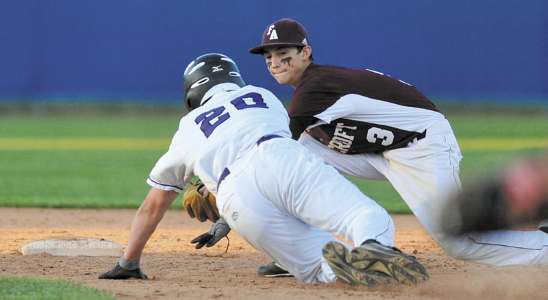 Staff photo by Michael G. Seamans Waterville Senior High School’s Josh Gormley (20) is tagged out by Foxcroft Academy’s Caleb Richard attempting to steal in the fifth inning of the Eastern Class B championship game Thursday at Mansfield Stadium in Bangor.
