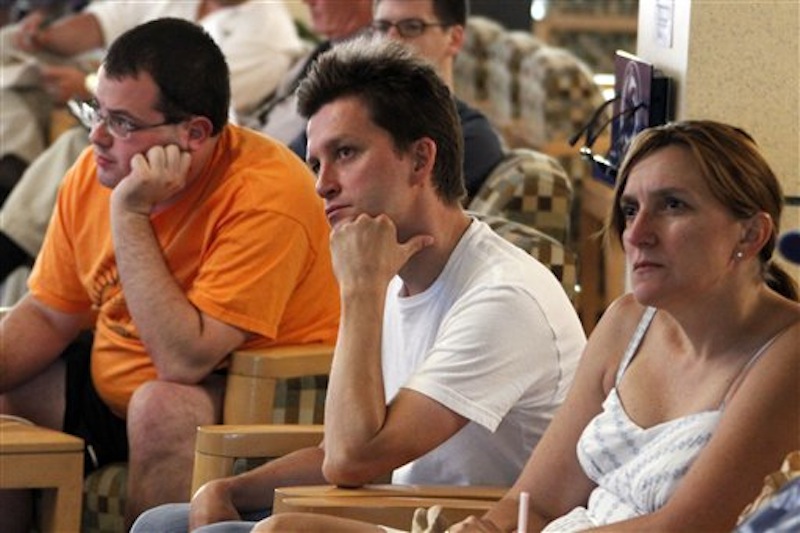 Penn State students gather around a television in the student HUB on Penn State University's main campus to listen to the news conference held by former FBI director Louis Freeh after the release of his report on the Jerry Sandusky child sex abuse scandal in State College, Pa., Thursday, July 12, 2012. Freeh said the most "saddening and sobering" finding from his group's report is Penn State senior leaders' "total disregard" for the safety and welfare of the ex-coach's child victims. (AP Photo/Gene J. Puskar)