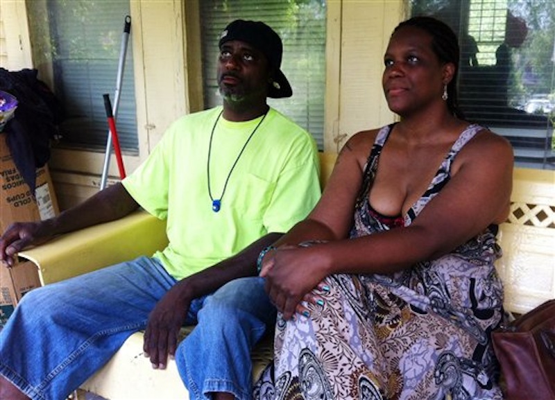 Eddie Miller and Yolanda McNair talks about their daughter, Adaisha Miller, in Detroit, Monday, July 9, 2012. The contact that came when Adaisha Miller hugged an off-duty Detroit police officer from behind caused his gun to go off, fatally shooting her in the chest, the police chief said Monday, July 9, 2012. Miller was celebrating what would have been her 25th birthday Monday. Chief Ralph Godbee called her death a tragic, "unfathomable" accident. "We are profoundly sad at their loss," he said, referring to Miller's family. Godbee said the gun was in a waist holster made of soft material, which would have allowed the trigger to be activated. (AP Photo/Mike Householder)