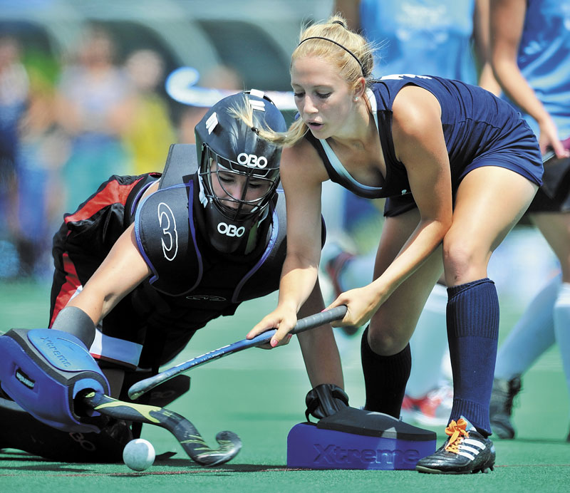 DENIED: East goalie Maicee Gustin of Dexter makes a save against Sage Hennessy of Fryeburg in the McNally Senior All-Star field hockey game Saturday at Colby College. The East defeated the West 3-2.