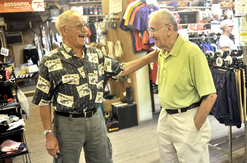 GOOD BYE, PRO: Harold Joseph, right, shares a laugh with long-time customer John Levesque, left, during Joseph’s retirement party Saturday at his store on Maine Street in Fairfield.