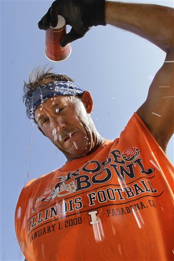 Concrete worker Lenny Rose pours water over his head on Thursday in an effort to cool off while building an industrial park in Springfield, Ill.