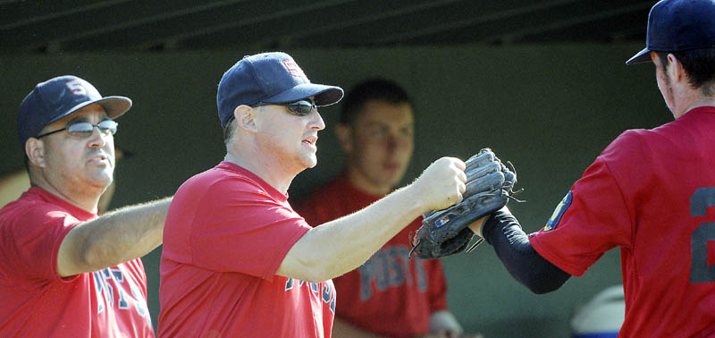 WAY TO GO: Messalonskee’s coaches Paul Jacobs, left, and Tom Dexter greet players during Post 51’s 5-1 win over Gardiner in the if necessary game oft the American Legion Baseball Zone 2 tournament on Monday in Augusta.