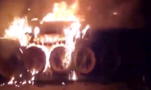 This image made from amateur video released by the Shaam News Network, purports to show a burning Syrian military tank in Damascus, Syria. Anti-regime activists say government forces are shelling a number of neighborhoods in and around the capital Damascus a day after a bomb killed three members of President Bashar Assad's inner circle.