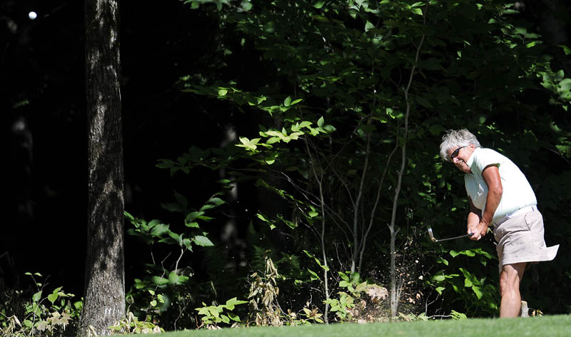TO THE GREEN: Barbara Rondeau, of Brunswick Country Club, chips onto a green Monday during the New England Women’s Golf Association Championship at Natanis Golf Course in Vassalboro.