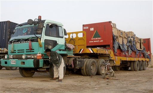 A driver washes his face near a truck carrying NATO supplies at the Pakistani-Afghan border, in Chaman, Pakistan, today. The first truck carrying supplies to American and NATO troops in Afghanistan has crossed the Pakistani border after a seven-month long closure of the supply routes by Pakistan ended earlier this week.