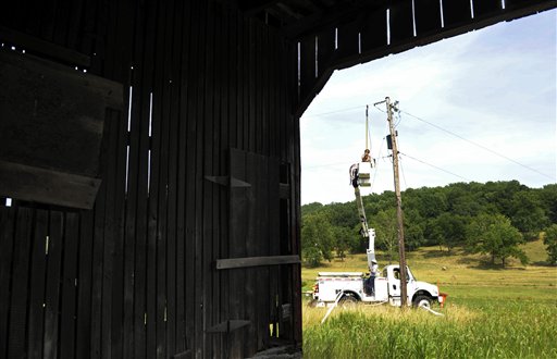 A Gulf Power lineman works to restore a power line near a barn in Middleburg, Va., Tuesday. Severe storms swept through the region, leaving many homes and businesses without electricity.