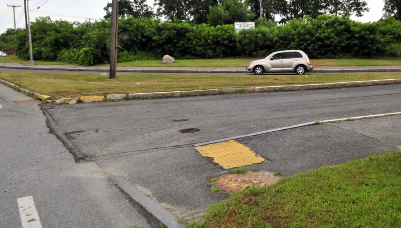 A motorist drives on Colby Circle where it intersects Front Street and College Avenue in Waterville near land where the new police station may be built. City councilors are also considering two other locations.