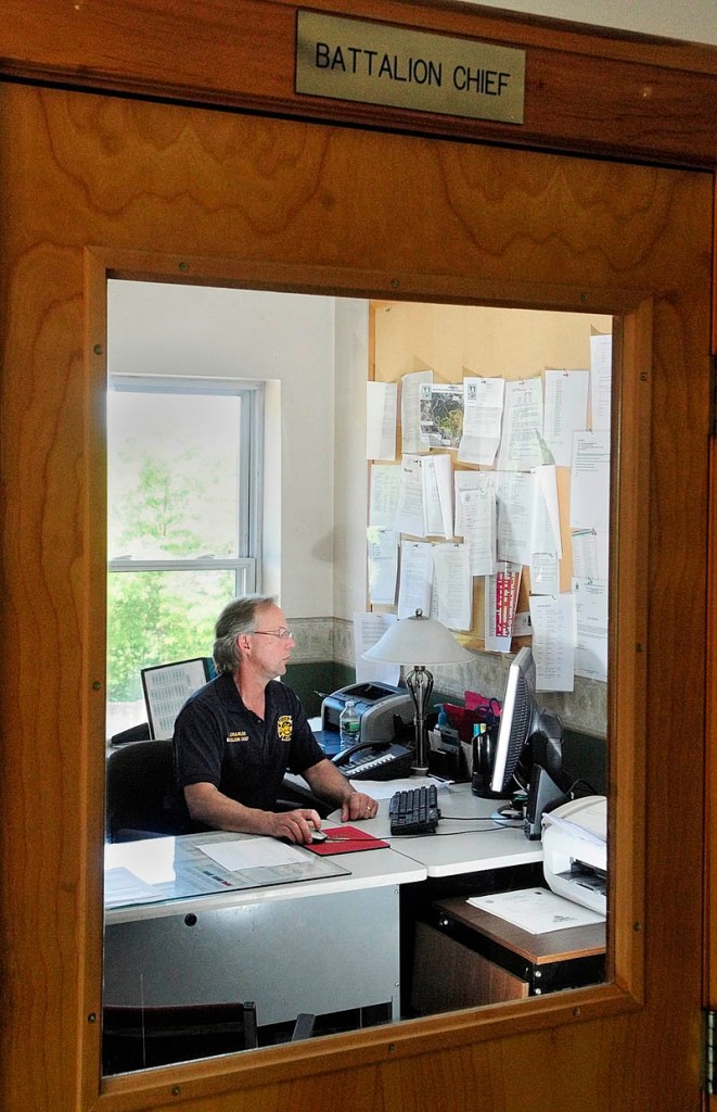 After his retirement luncheon, Augusta Fire Battalion Chief Ed Charles finishes up his last report on Friday afternoon in Hartford Fire Station. Charles started working on a rescue unit in 1987 and his final call was an early morning chimney fire.