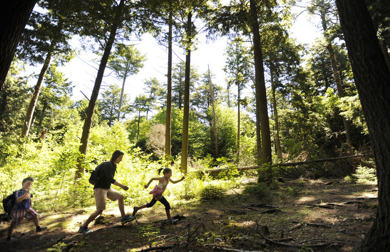 Gina Perow of Harpswell hikes along a trail at the Skolfield Shores Preserve along with her son, Sam, 5, and daughter, Sophie, 7. The Harpswell Heritage Land Trust has preserved more than 256 acres on 11 preserves since its formation in 1983.