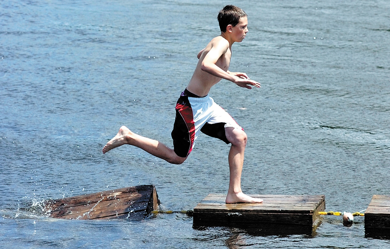 Nathan Vintinner, 14 of Richmond, races across a string of lobster crates floating in the Kennebec River on Saturday during last summer's Richmond Days events at Fort Richmond Waterfront Park.