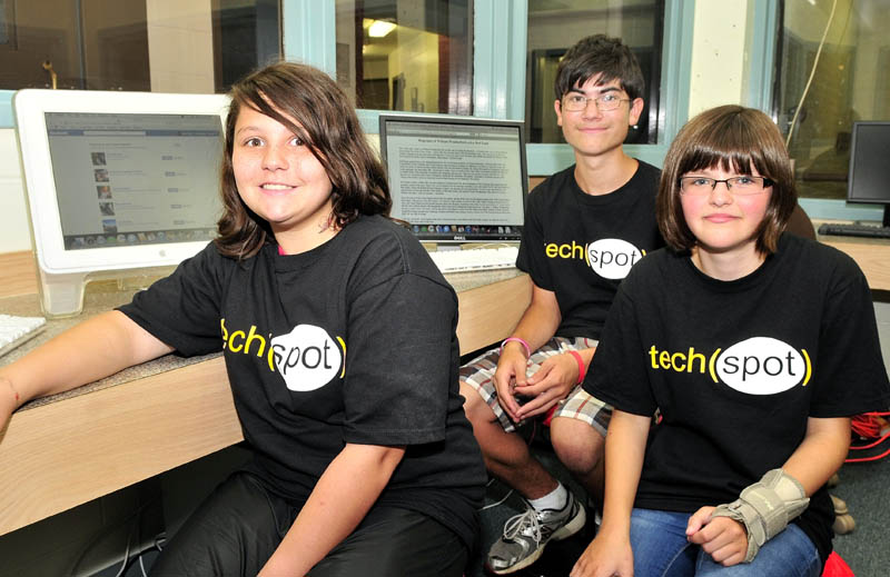 The Tech Spot members, from left, Hailee Buzzell, Micah Weatherford and Grace Pollis sit inside the grist mill in Skowhegan where they will help seniors learn to use computers.