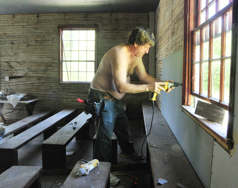 Don Laliberte, of Mount Vernon, owner of Don Laliberte Dry Wall, hangs drywall on Friday at the Wayne Town House.