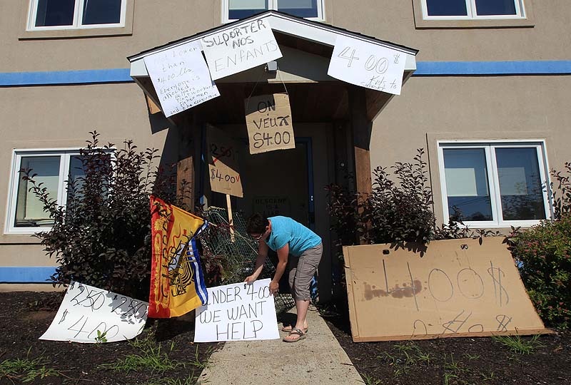 FRUSTRATED FISHERMEN: Over two hundred lobster fishermen converge on the office of Federal fisheries minister Keith Ashfield on Wednesday. Above protestors put signs up around the entrance to the office.