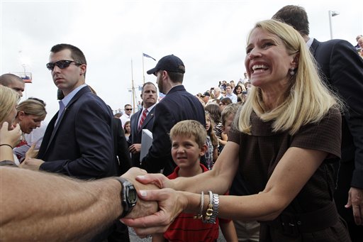 FILE - In this Aug. 11, 2012 file photo, Janna Ryan, wife of Republican Vice Presidential candidate, Rep. Paul Ryan, R-Wis., partially visible behind her, greets crowd members in Norfolk, Va. Like her husband, Janna Ryan is a Washington veteran as a legislative staffer, attorney and lobbyist. Now a stay-at-home mom, she comes from a family rooted deep in Oklahoma politics. (AP Photo/Mary Altaffer, File )