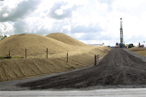 A crew works on a drilling rig at a well site for shale based natural gas in Zelienople, Pa., in this June 25, 2012, photo,