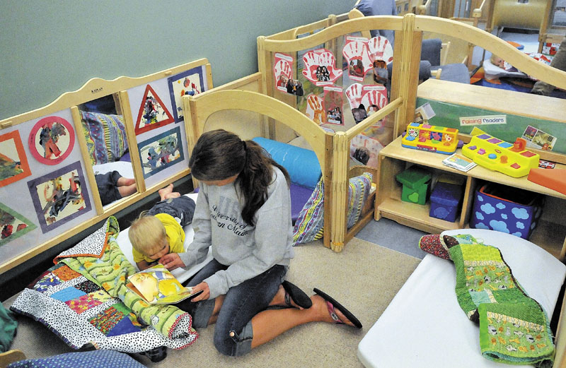 Monica Pollard reads a story to Landon Dwelley, 1, before nap time at Head Start at Educare Central Maine in Waterville on Friday.