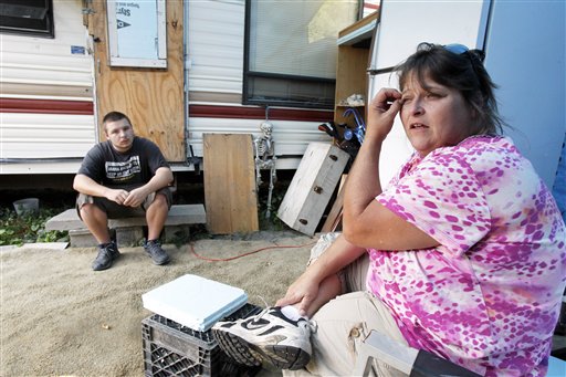 Janet Lumbra and her son, Riley, sit at their temporary home in East Granville, Vt.