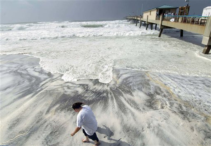 L'Rena Anderson leans into the wind as she walks along the beach on Okaloosa Island in Fort Walton Beach, Fla., Tuesday, Aug. 28, 2012. Anderson was among many local residents who turned out to watch the effects of Hurricane Isaac as it churns through the Gulf of Mexico toward an expected landfall in Louisiana. (AP Photo/Northwest Florida Daily News, Devon Ravine)