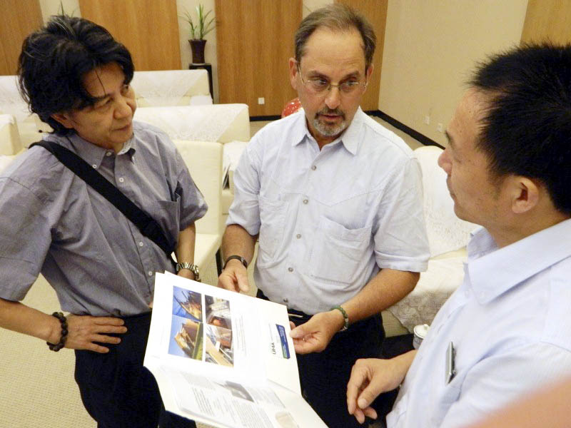 ACROSS CULTURES: Professor Robert Katz with interpreter, left, and vice director of Memorial Hall of the Victims in Nanjing Massacre by Japanese Invaders presenting educational materials developed by the Holocaust and Human Rights Center of Maine.