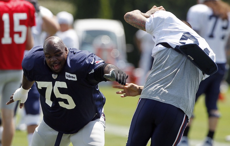 New England Patriots' Vince Wilfork (75) spars with Aaron Hernandez, right, during NFL football training camp in Foxborough, Mass., Saturday, July 28, 2012. (AP Photo/Michael Dwyer)