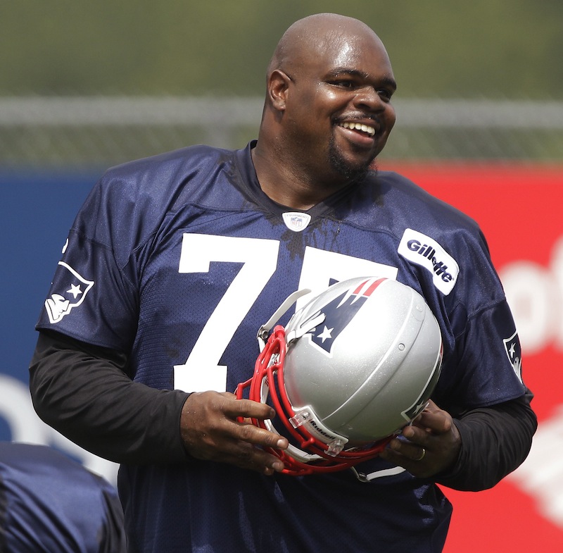 New England Patriots nose tackle Vince Wilfork smiles as he walks between drills during practice on the second day of NFL football training camp in Foxborough, Mass., Friday, July 27, 2012. (AP Photo/Stephan Savoia)