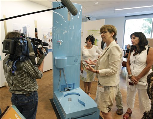 Tove Larsen, second from right, of Eawag, the Swiss Federal Institute of Aquatic Science and Technology, talks about their diversion toilet at the Reinventing the Toliet Fair on Tuesday in Seattle.
