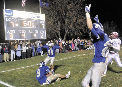 TIS THE SEASON: Lawrence High School’s Spencer Casey, 9, lands in the endzone after a touchdown catch in the second quarter against Bangor High School at Lawrence High School in Oakland last season. The high school football season kicks off tonight.