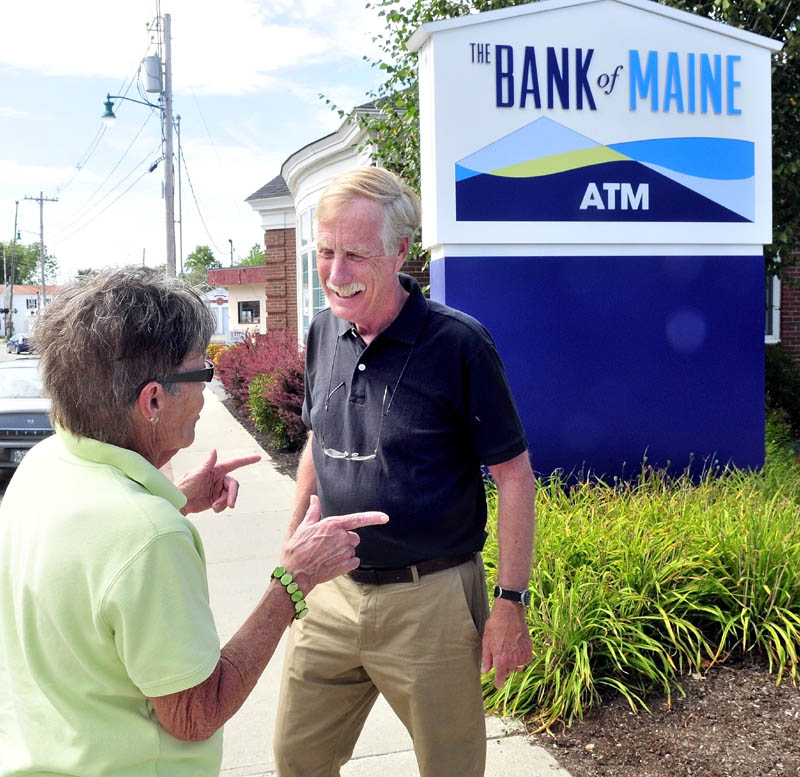 U.S. Senate candidate Angus King speaks with Penny Rafuse of Waterville on Monday during a campaign stop in Oakland. King left the Board of Directors for The Bank of Maine to allow him to campaign for U.S. Senate.