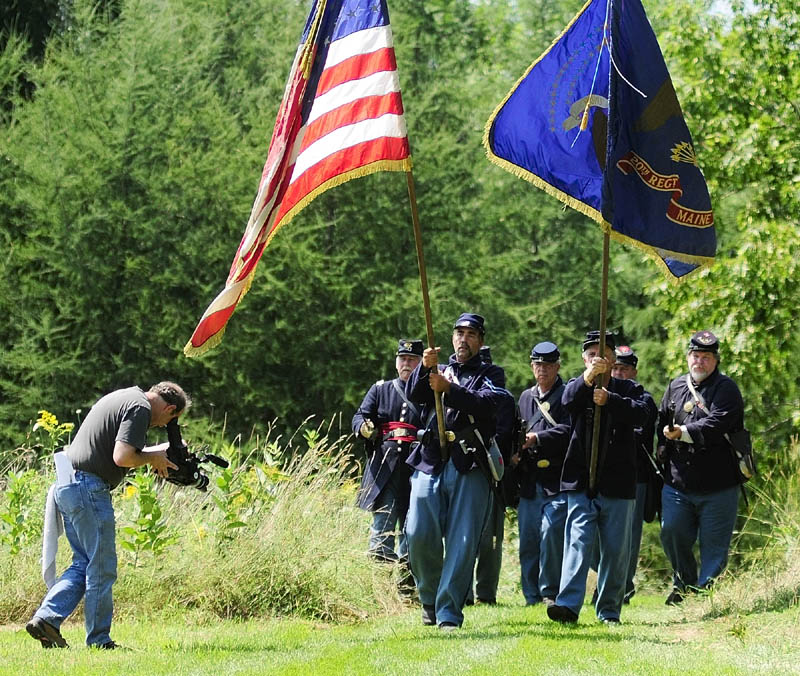 Nick Woodward, a videographer for Maine Public Broadcasting, records a group of soldiers during a Civil War reenactment event on Saturday afternoon at Viles Arboretum in Augusta. He was part of a crew working on a project about Maine units in the Civil War that will be shown next summer.