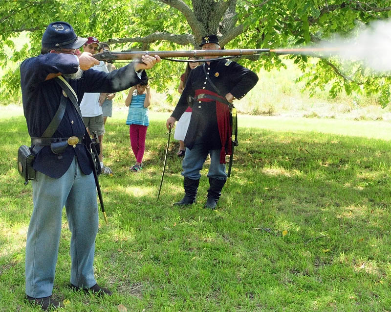 Art Custer, of Belfast, fires his weapon during a Civil War reenactment event on Saturday afternoon at Viles Arboretum in Augusta.